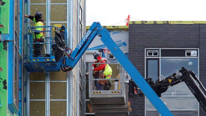 FILE PHOTO: Construction workers work on a new apartment building in Ottawa