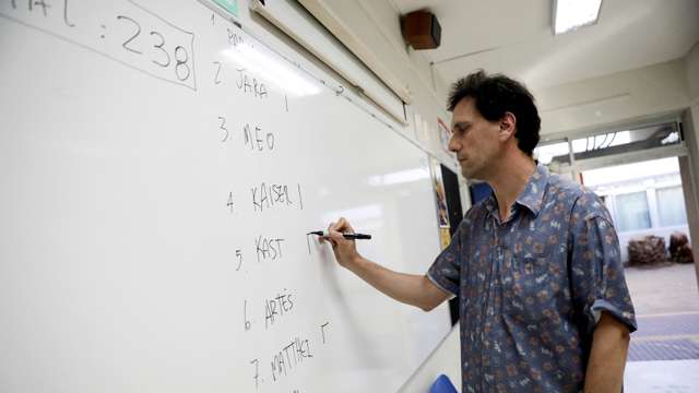 An electoral worker writes down the number of votes cast for each candidate after the polls closed in the presidential election, in Santiago, Chile, November 16, 2025. REUTERS/Juan Gonzalez
