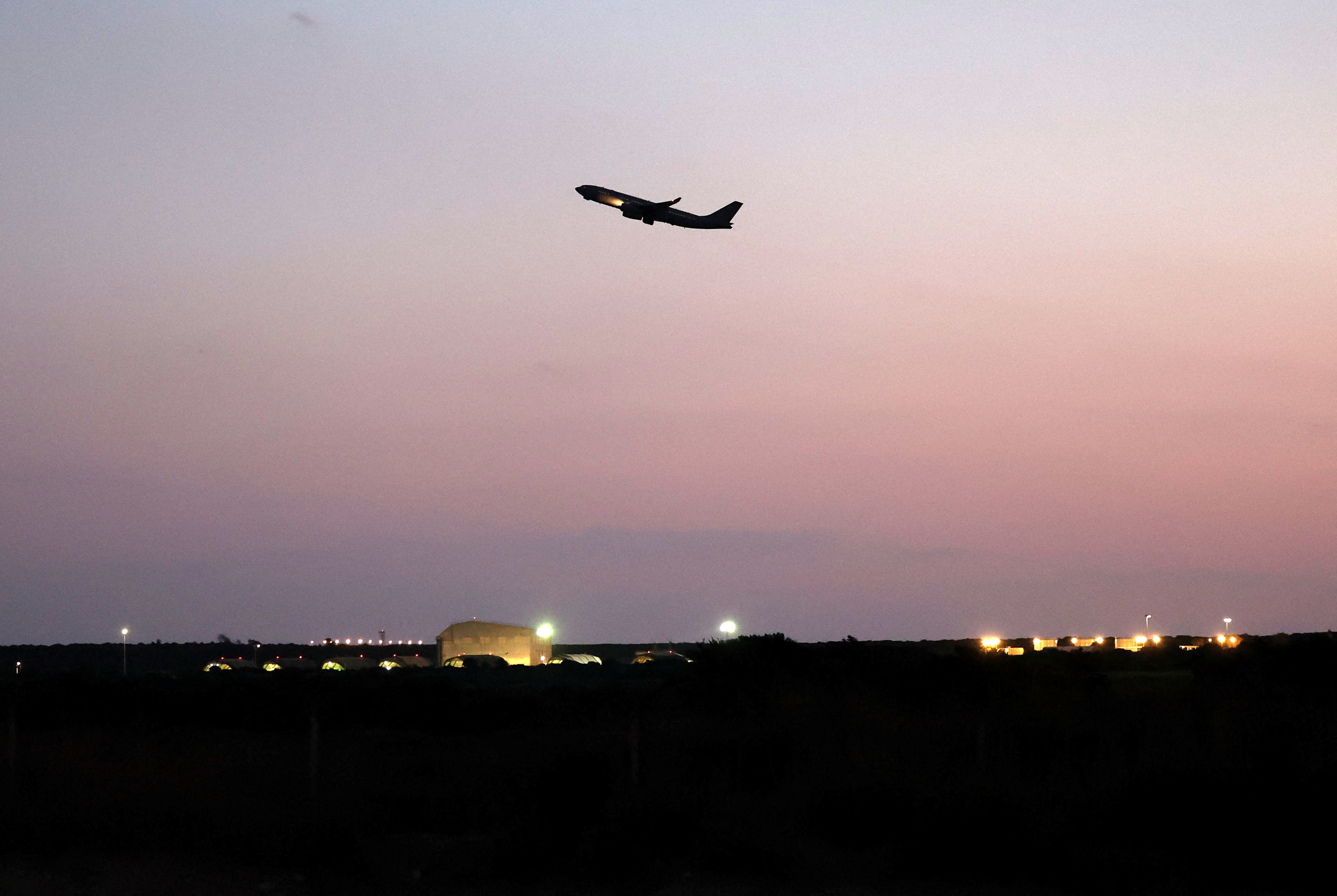 An aircraft flies near RAF Akrotiri, a British sovereign base that was hit by a drone early on Monday