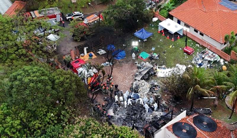 Officials work at the site of a plane crash in Vinhedo, Sao Paulo
