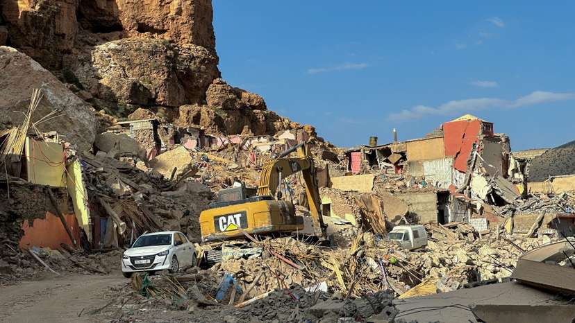 An excavator is parked near houses that were damaged by last month's deadly earthquake, in Imi N'Tala village