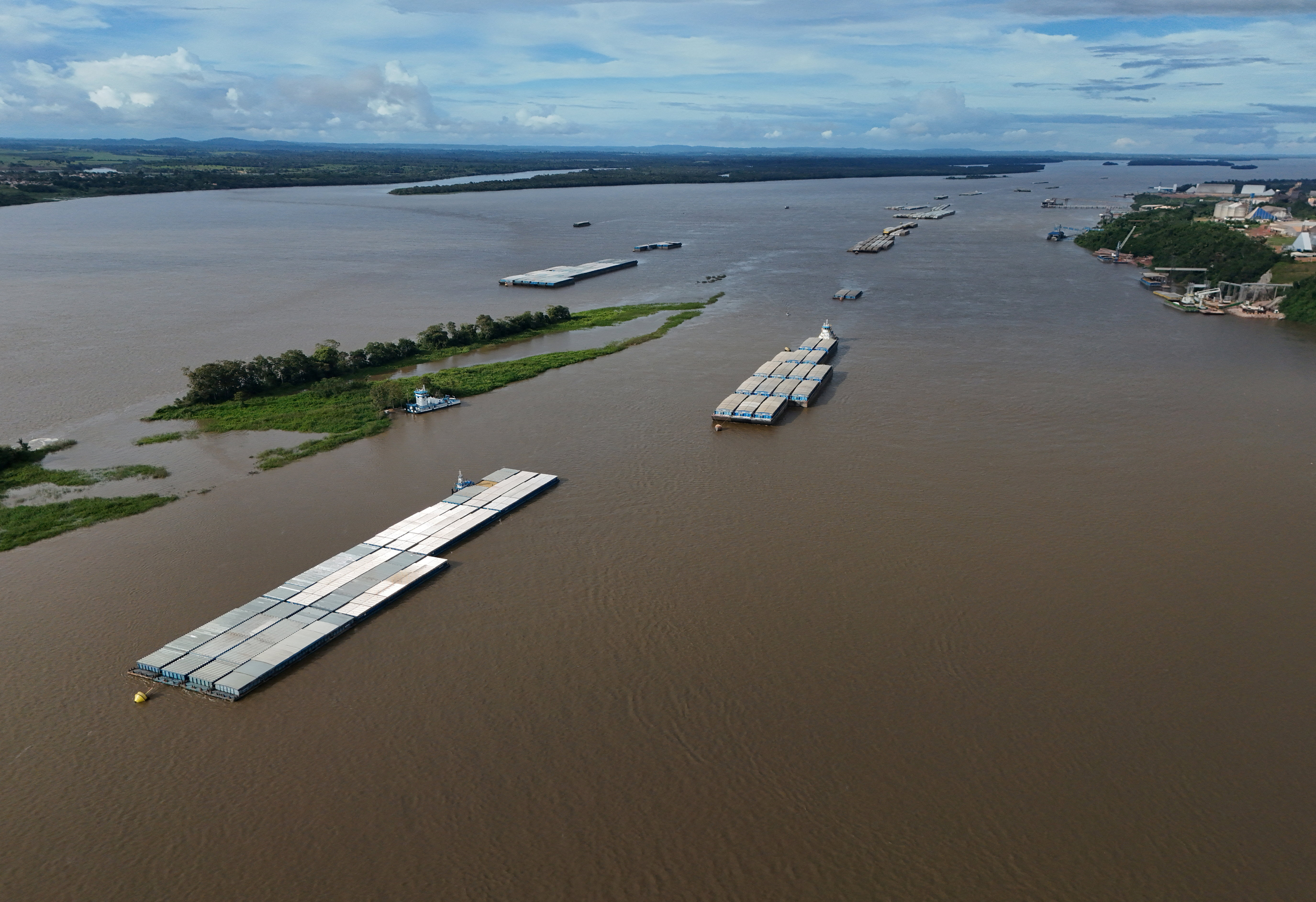 A drone view of a grain barge on the Tapajos river, while trucks loaded with soybeans wait to unload at the port of Miritituba, as heavy grain traffic in the region has led to long lines during Brazil's harvest shipping season, in Miritituba, Brazil, February 25, 2026. REUTERS/Adriano Machado