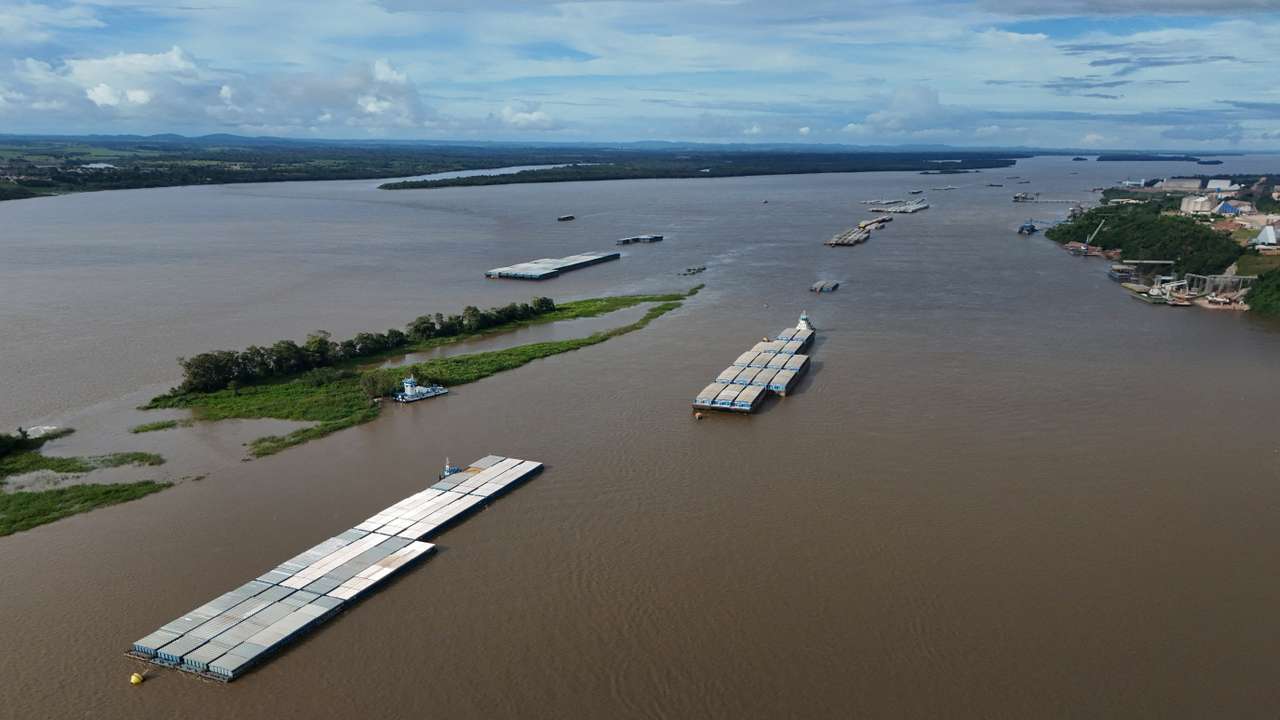 A drone view of a grain barge on the Tapajos river, while trucks loaded with soybeans wait to unload at the port of Miritituba, as heavy grain traffic in the region has led to long lines during Brazil's harvest shipping season, in Miritituba, Brazil, February 25, 2026. REUTERS/Adriano Machado