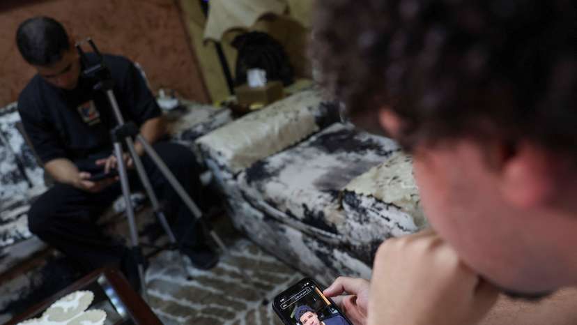 Abdulrahman Hisham, 20, an Egyptian social media content creator, looks at his page in Cairo