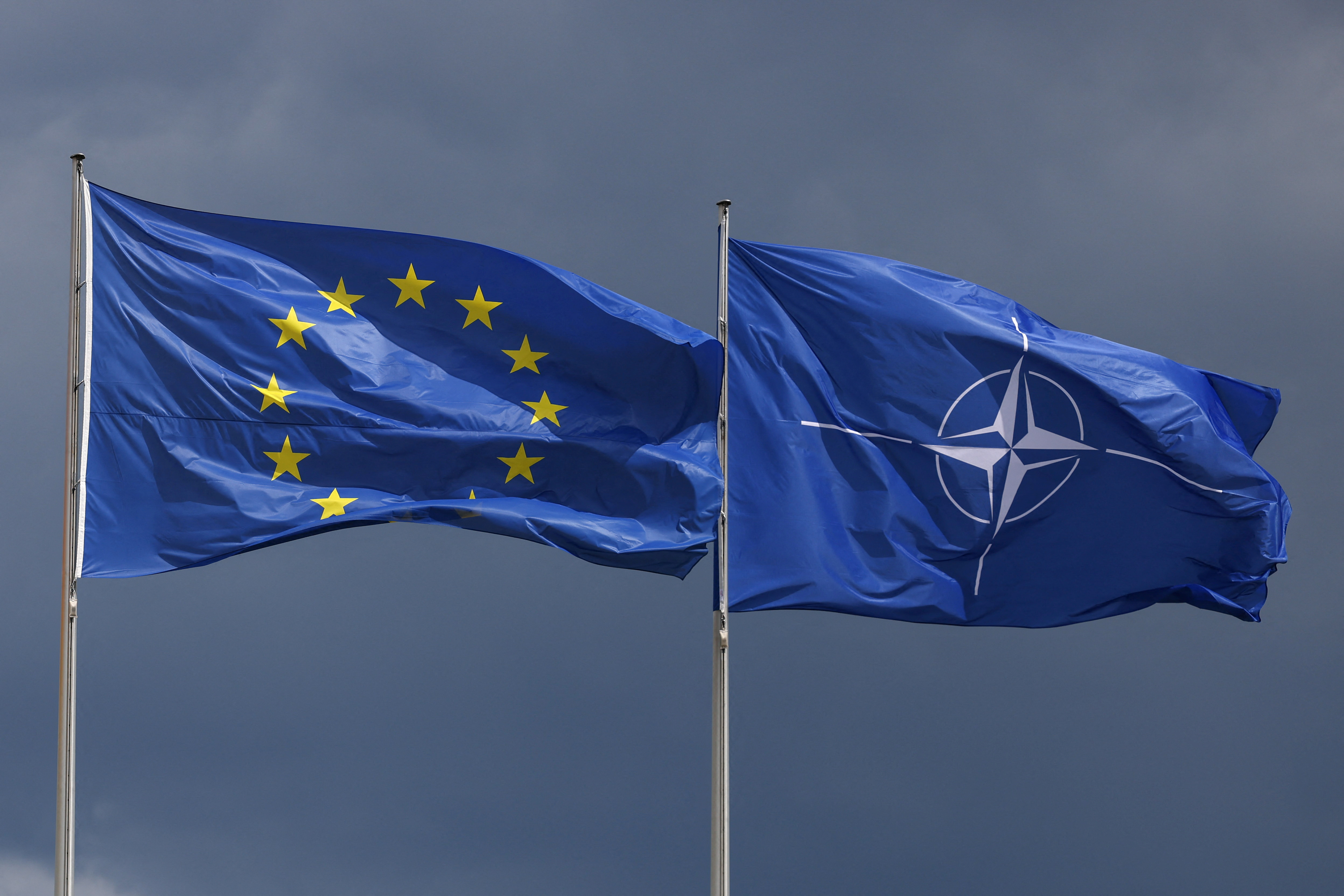 EU and NATO flags fly outside federal chancellery in Berlin
