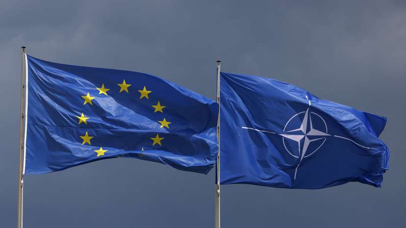 EU and NATO flags fly outside federal chancellery in Berlin