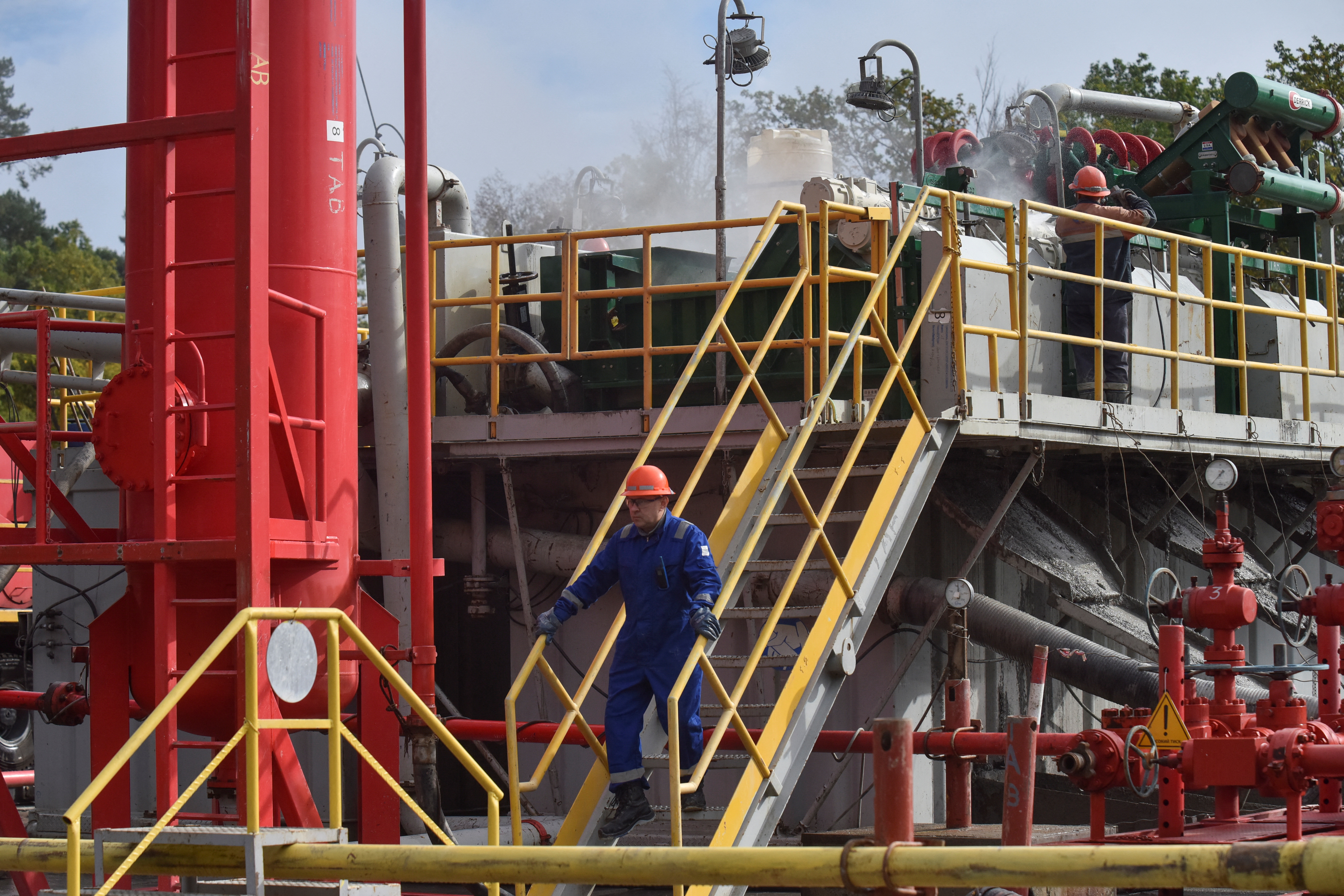 Employees work at a gas well of Ukraine's state energy company Naftogaz in Lviv region