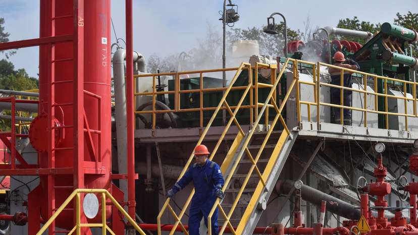 Employees work at a gas well of Ukraine's state energy company Naftogaz in Lviv region