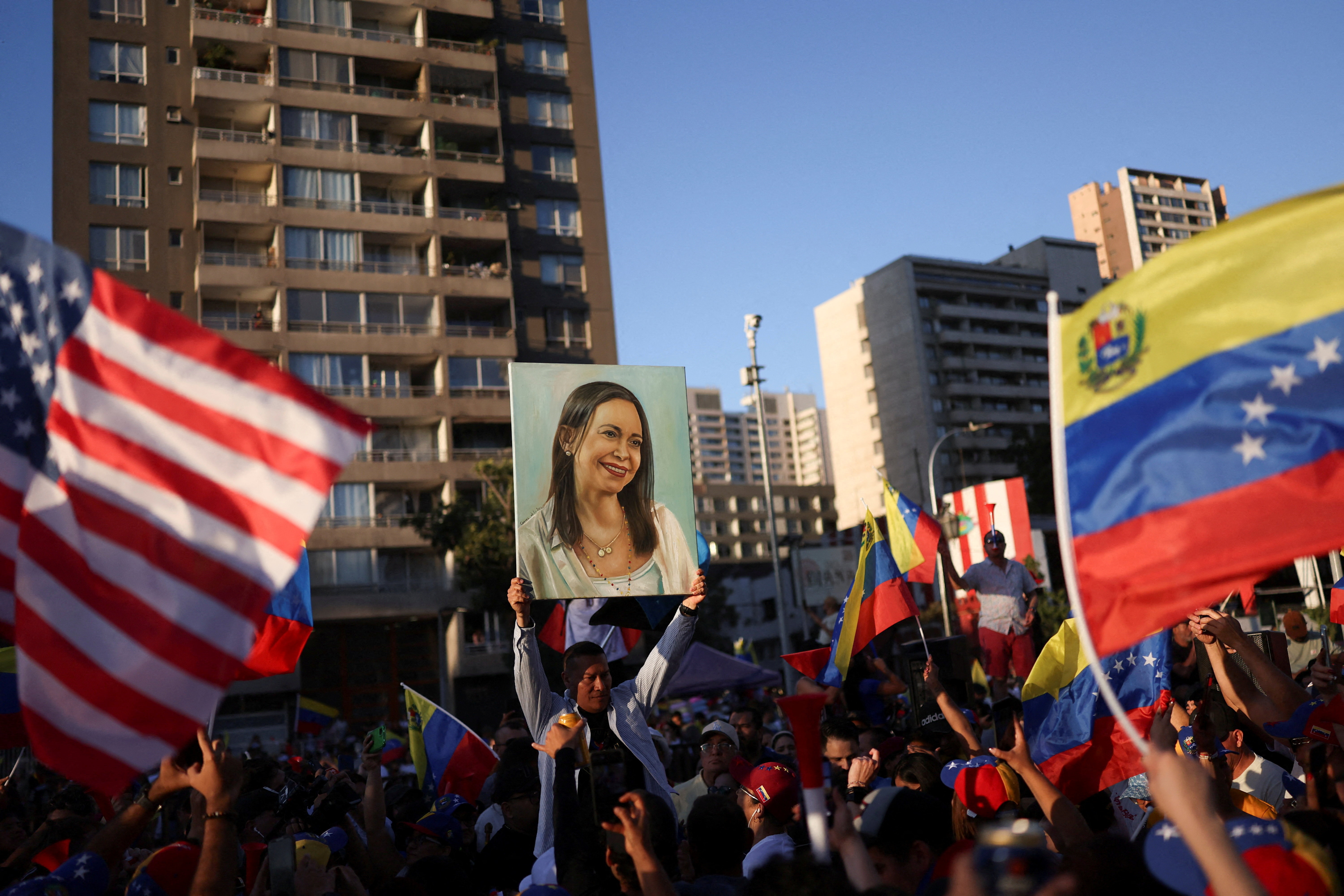 People celebrate after the U.S. struck Venezuela and captured its President Nicolas Maduro and his wife Cilia Flores, in Santiago