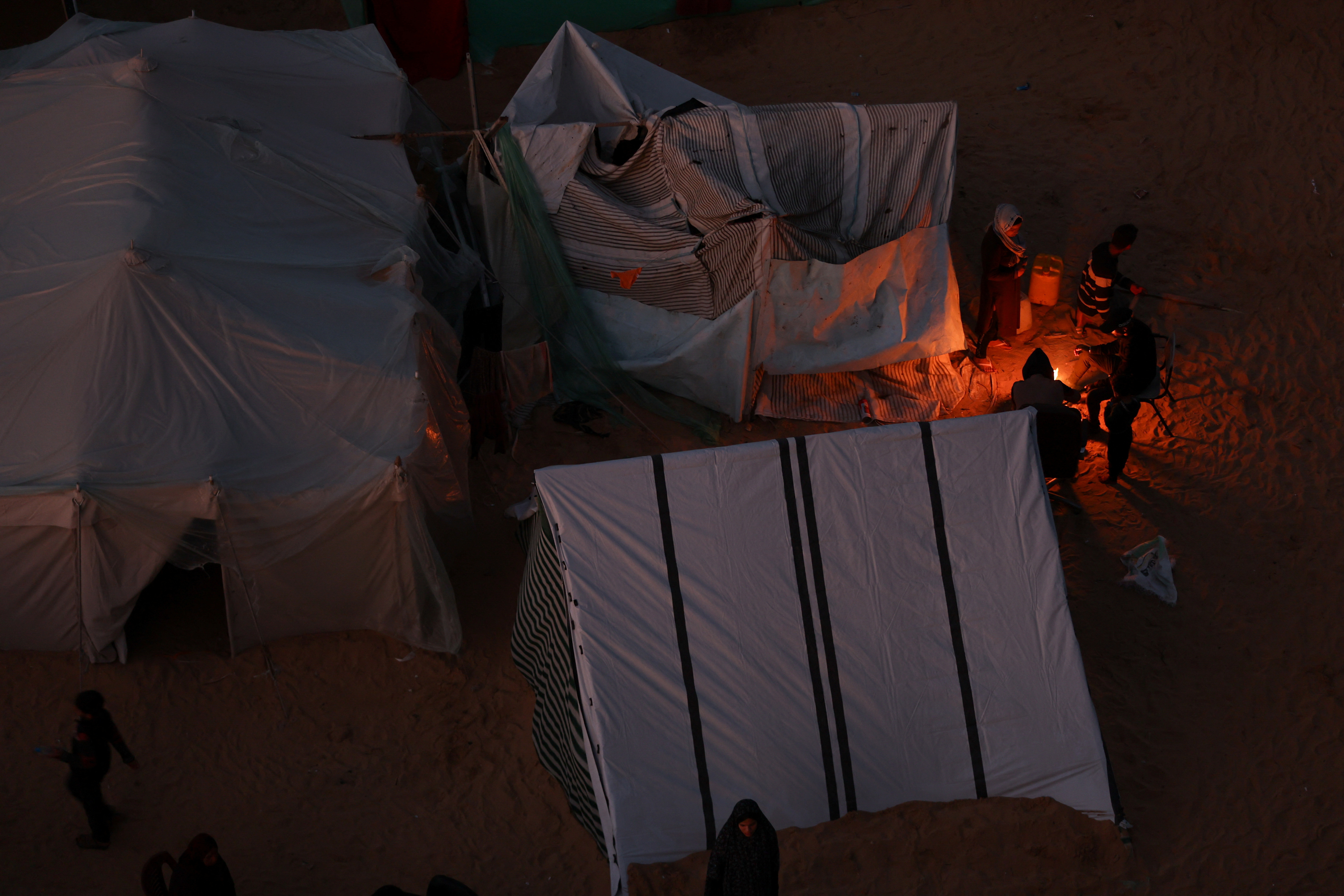 Displaced Palestinians, who fled their homes due to Israeli strikes, shelter in a tent camp, in Rafah