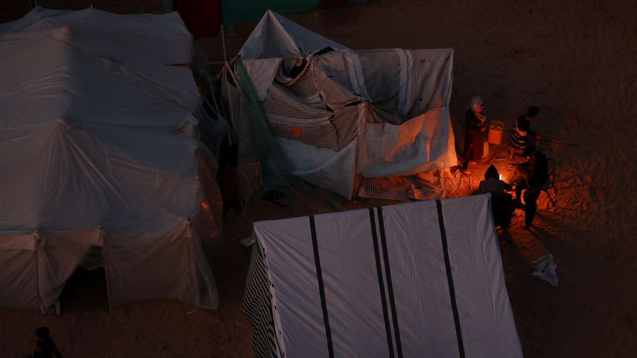 Displaced Palestinians, who fled their homes due to Israeli strikes, shelter in a tent camp, in Rafah