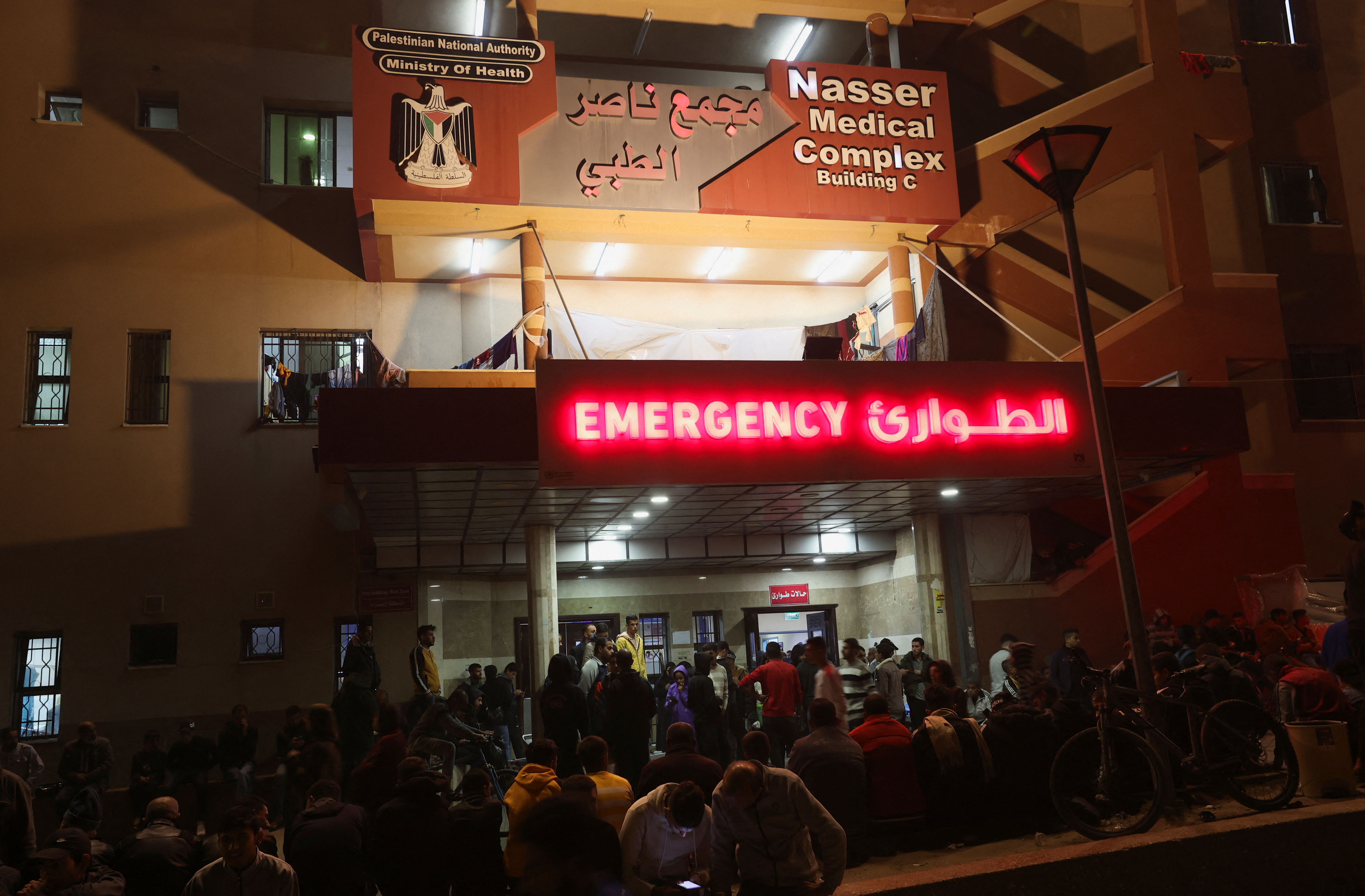 Palestinians gather outside Nasser hospital following Israeli strikes, in Khan Younis