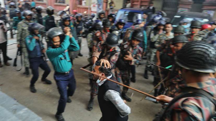Law enforcers charge batons to disperse followers gathered to demand the release of their leader Chinmoy Krishna Das, at the Chattogram Metropolitan Magistrate Court, in Chattogram