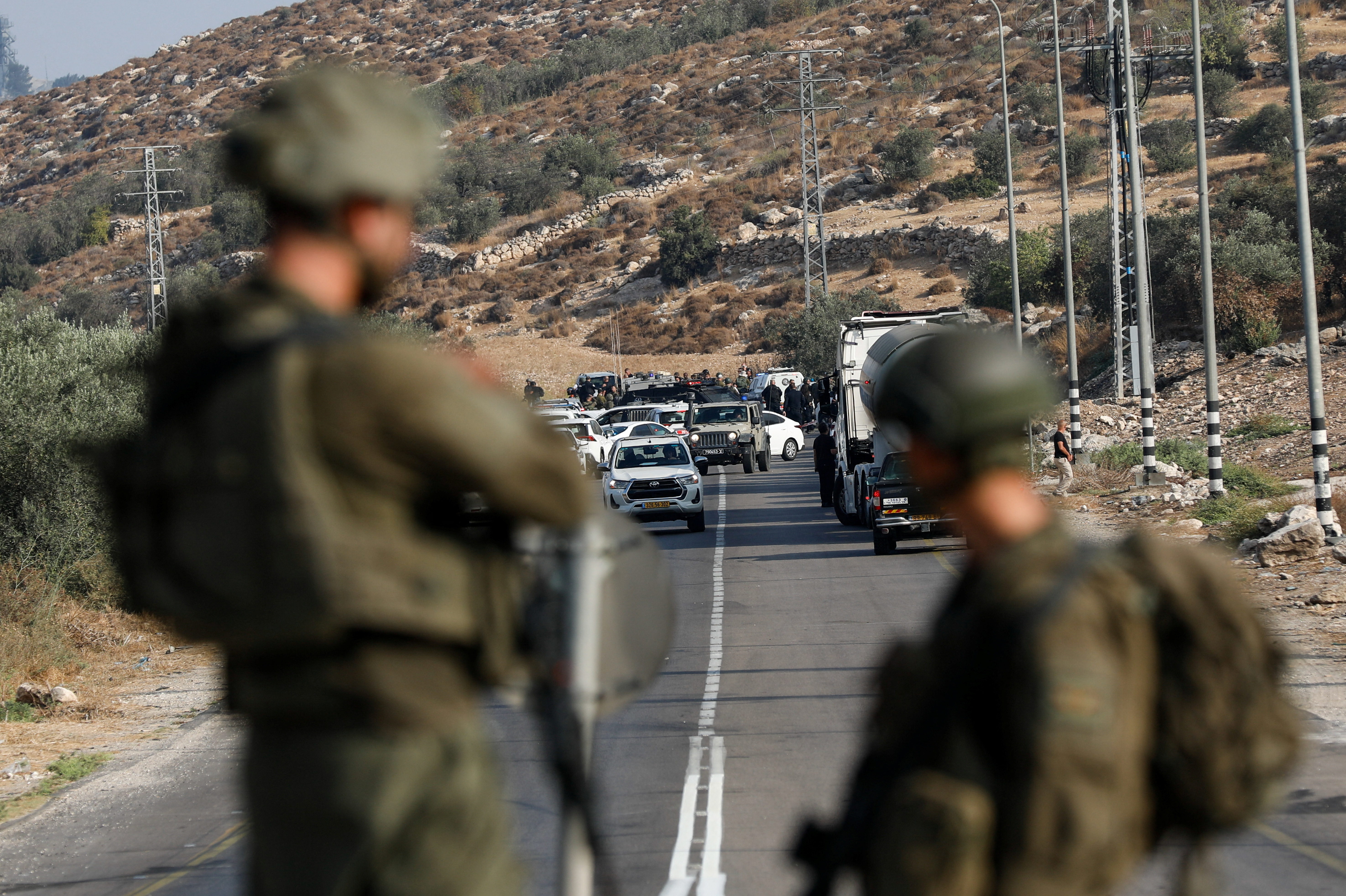 Israeli forces patrol near a shooting scene, near Hebron in the West Bank