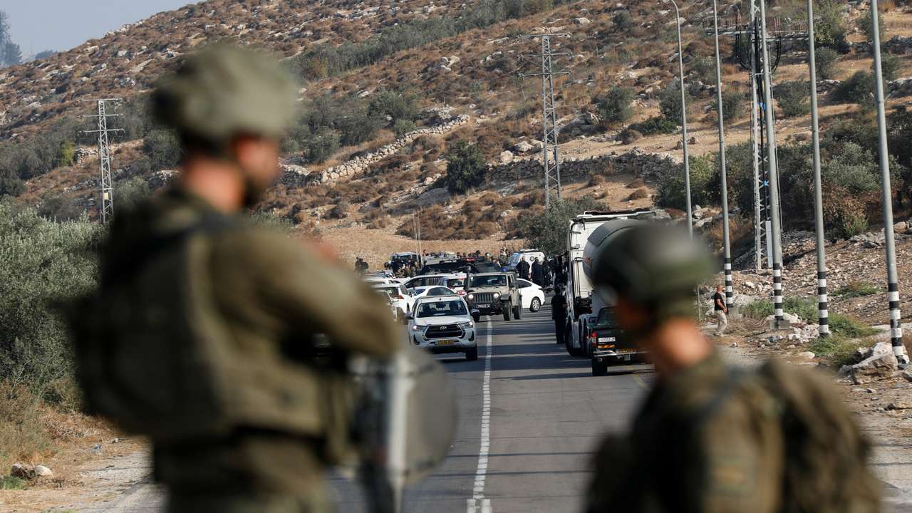 Israeli forces patrol near a shooting scene, near Hebron in the West Bank