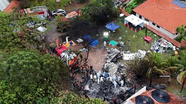 Officials work at the site of a plane crash in Vinhedo, Sao Paulo