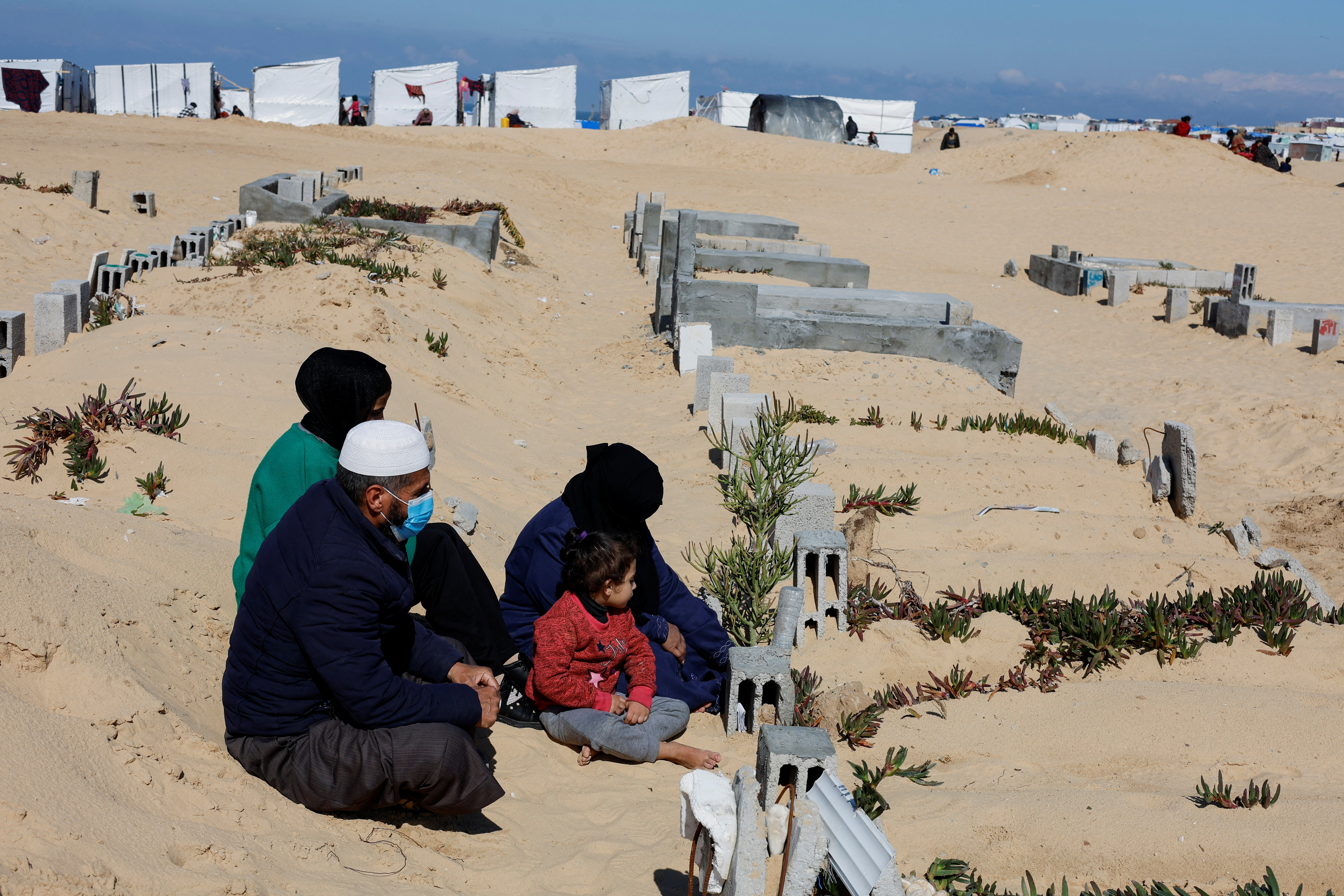 Displaced Palestinians shelter in a cemetery in Rafah in the southern Gaza Strip