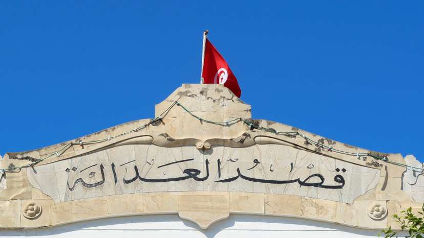 A Tunisian flag flutters atop of the Palace of Justice building in Tunis