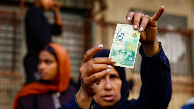 As the guns fall silent, Gazans find newly-reopened banks have no cash in Nuseirat