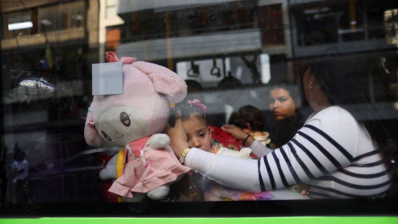 Migrants outside the Venezuelan embasssy waiting for a flight back to their country