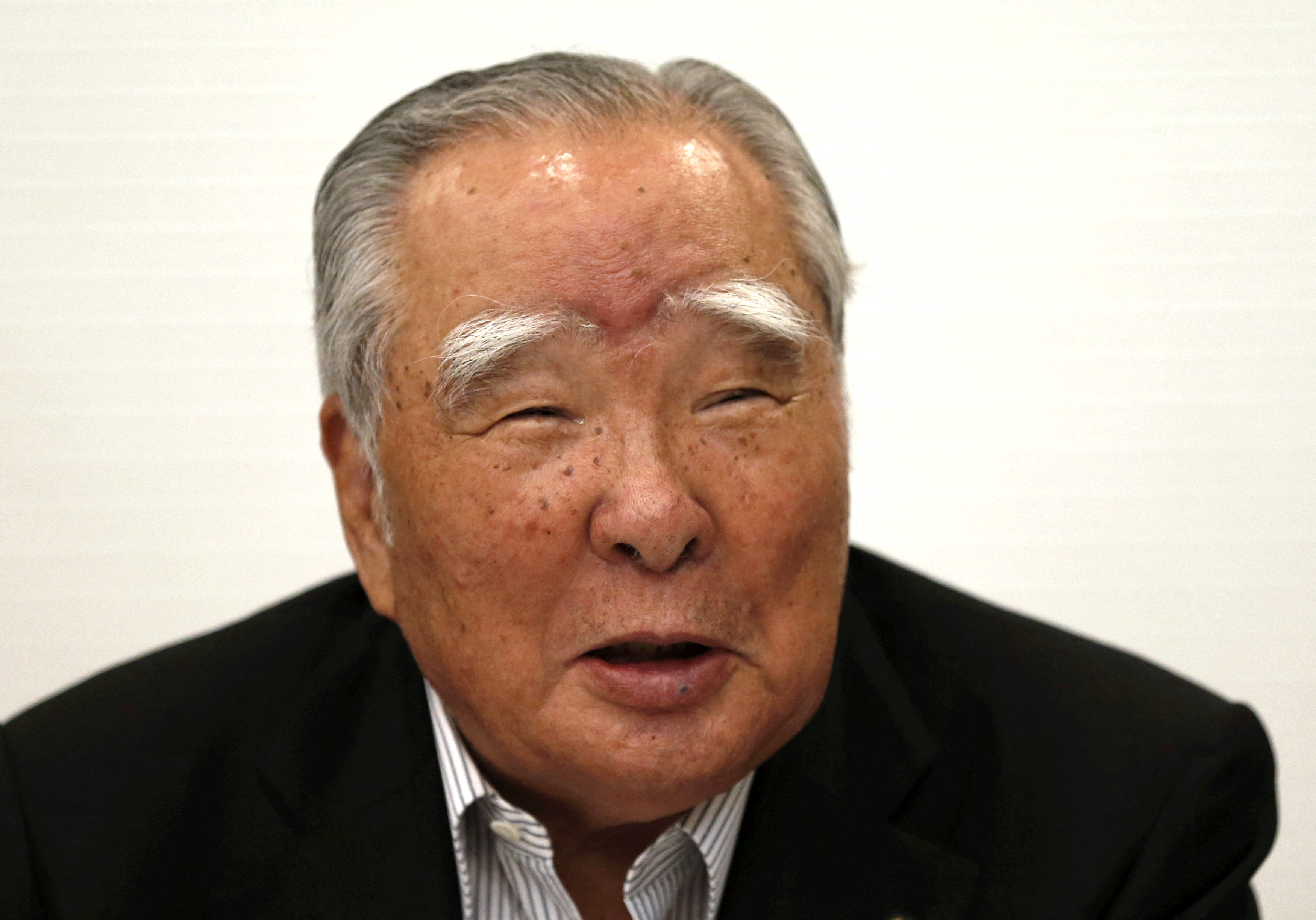 FILE PHOTO: Suzuki Motor Chairman and CEO Osamu Suzuki attends a news conference in Tokyo