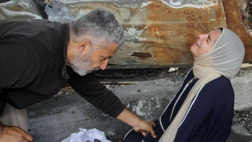 Mourners react next to the bodies of Palestinians killed in an Israeli strike, in Gaza City