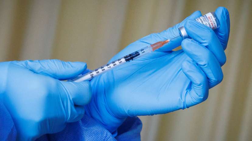 FILE PHOTO: A nurse prepares a vaccine shot as the German embassy begins its roll out of BioNTech COVID-19 vaccines for German expatriates at a Beijing United Family hospital in Beijing