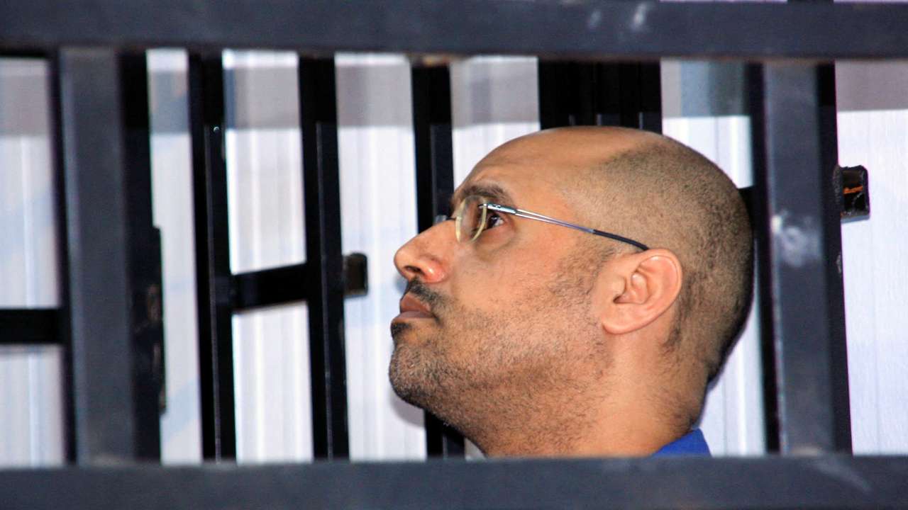 FILE PHOTO: Saif al-Islam Gaddafi, son of late Libyan leader Muammar Gaddafi, attends a hearing behind bars in a courtroom in Zintan