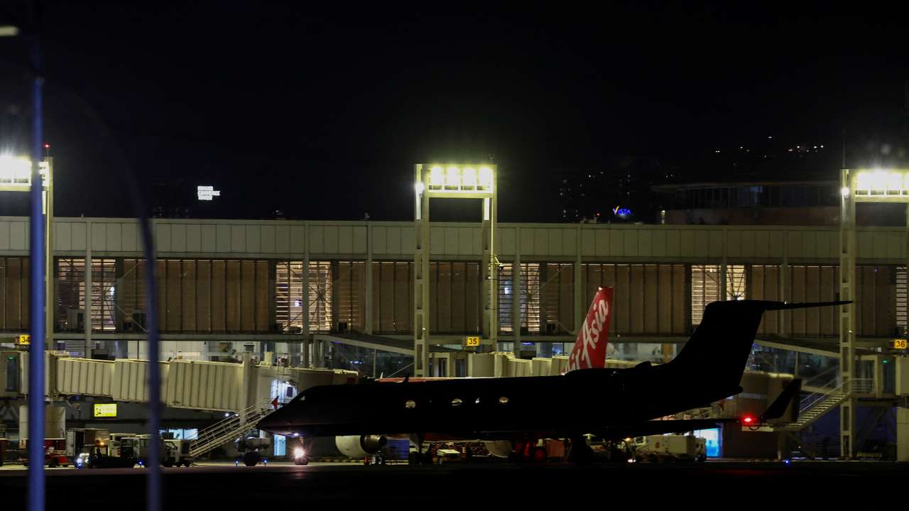 Former Philippine President Duterte boards a plane at Villamor Airbase after being arrested