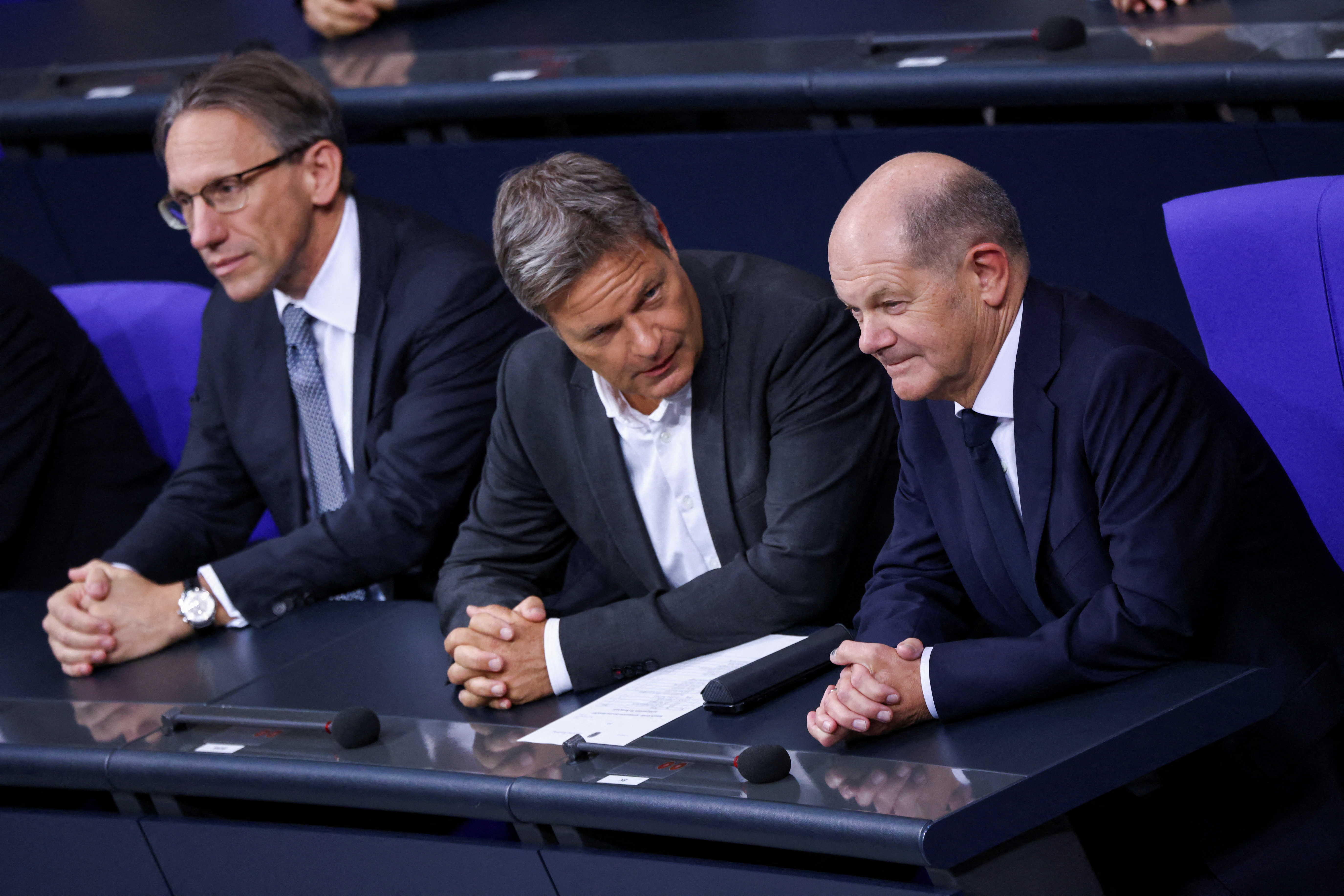 FILE PHOTO: Germany's newly appointed Finance Minister Joerg Kukies, German Economy and Climate Minister Robert Habeck and German Chancellor Olaf Scholz sit at the lower house of parliament, Bundestag in Berlin,