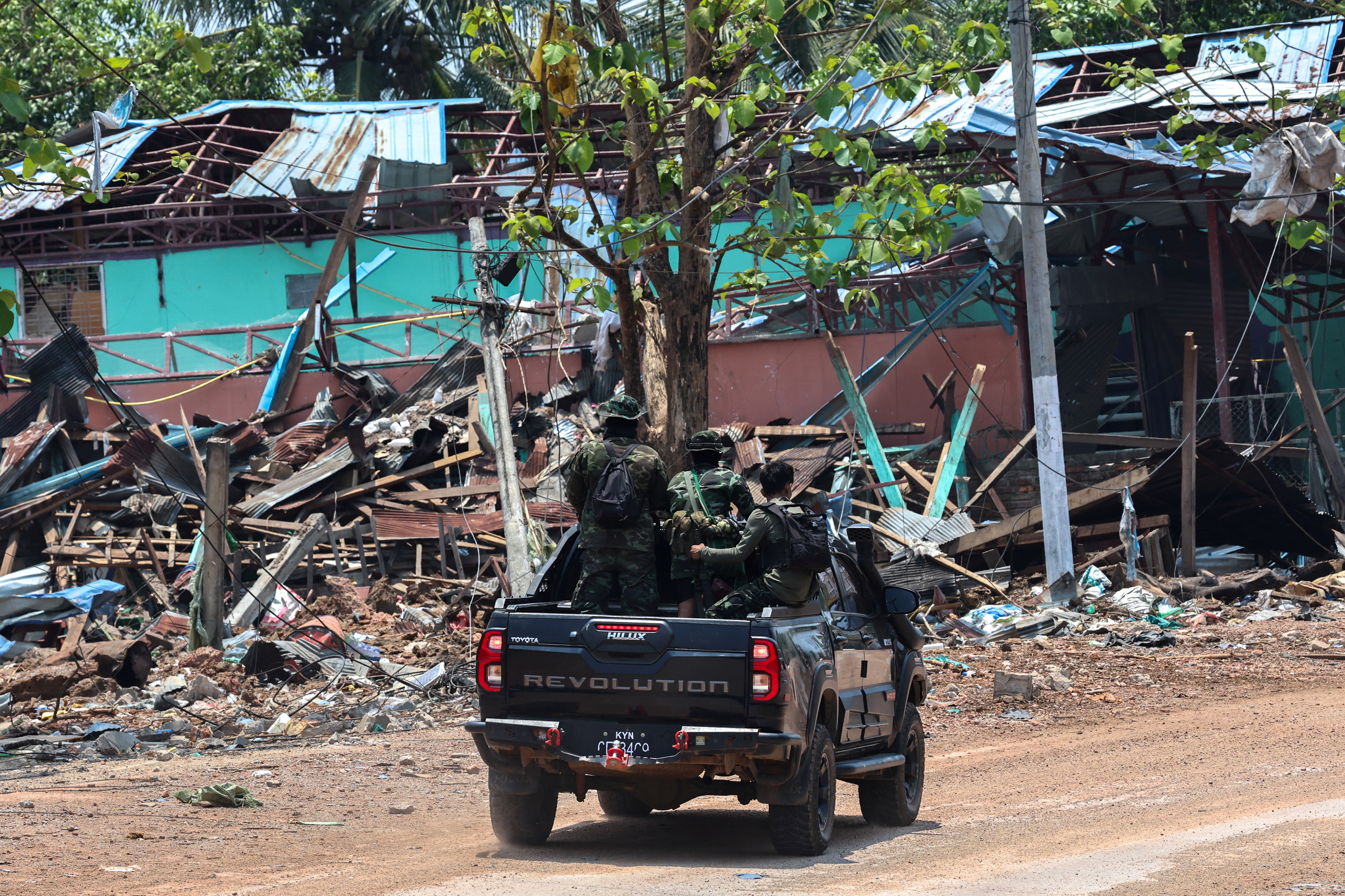 FILE PHOTO: Soldiers from the Karen National Liberation Army (KNLA) patrol , next to an area destroyed by Myanmar's airstrike in Myawaddy