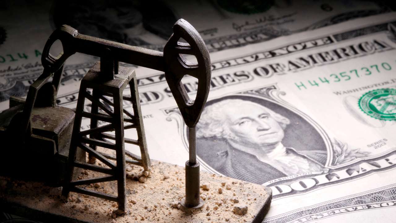 FILE PHOTO: A 3D-printed oil pump jack is placed on dollar banknotes in this illustration picture