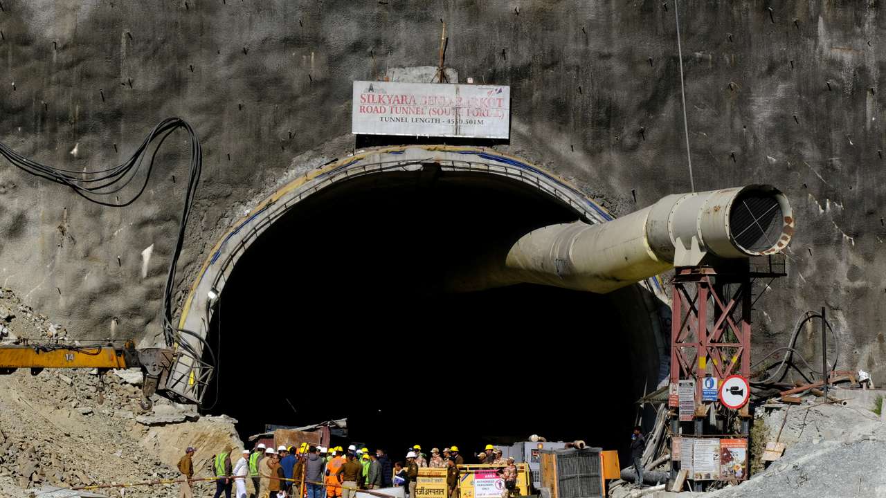 FILE PHOTO: Members of rescue teams stand at the entrance of a tunnel where 40 road workers are trapped after a portion of the tunnel collapsed, in Uttarkashi