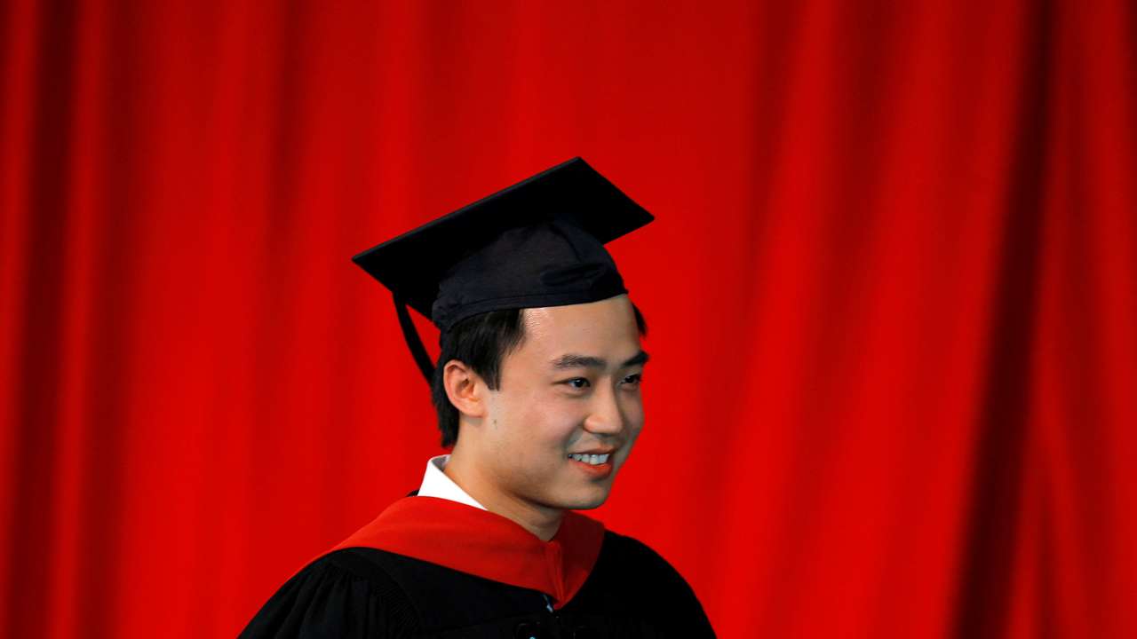 FILE PHOTO: Bo Guagua, son of fallen Chinese politician Bo Xilai, walks offstage after receiving his masters degree at Harvard University in Cambridge