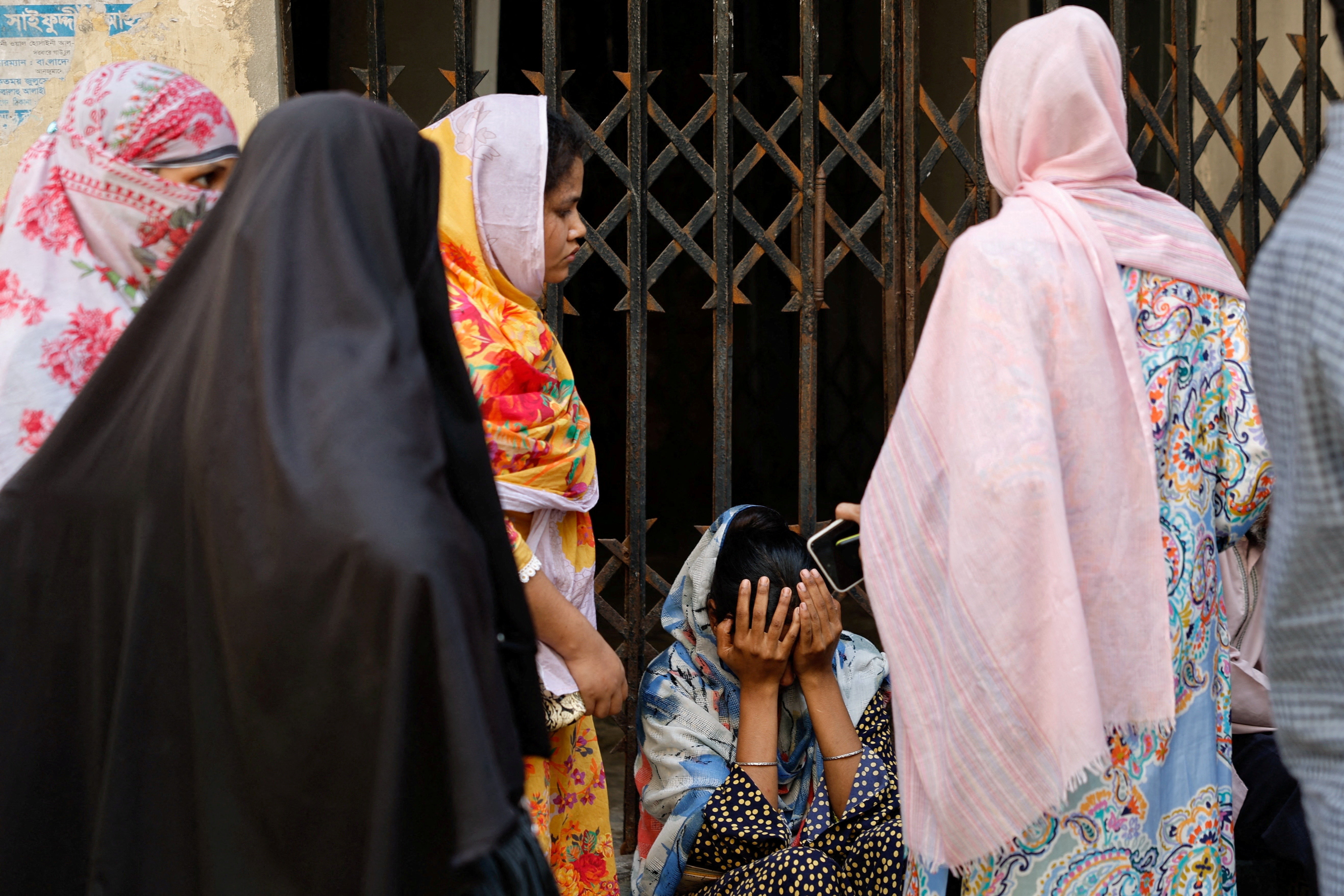 People mourn relative at Dhaka Medical College Hospital morgue following chemical warehouse fire, in Dhaka