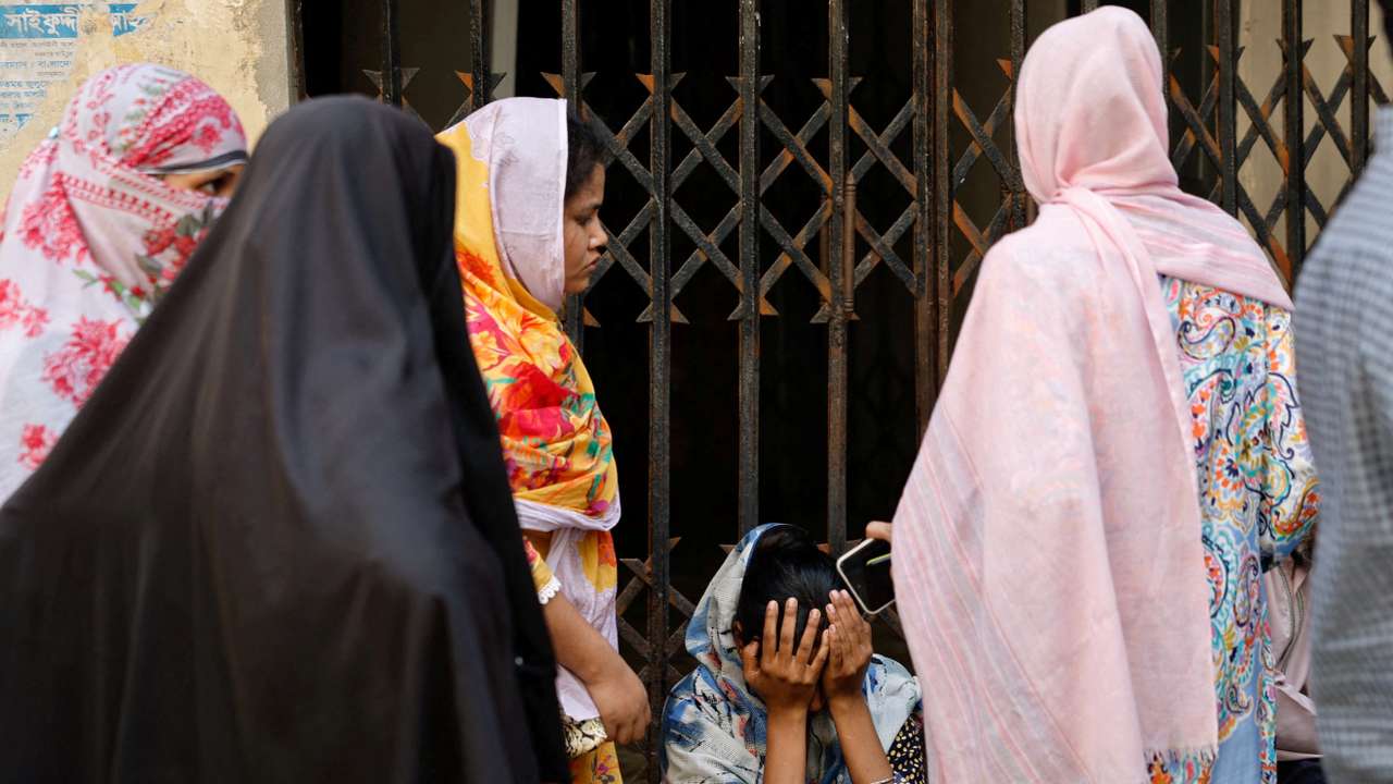 People mourn relative at Dhaka Medical College Hospital morgue following chemical warehouse fire, in Dhaka