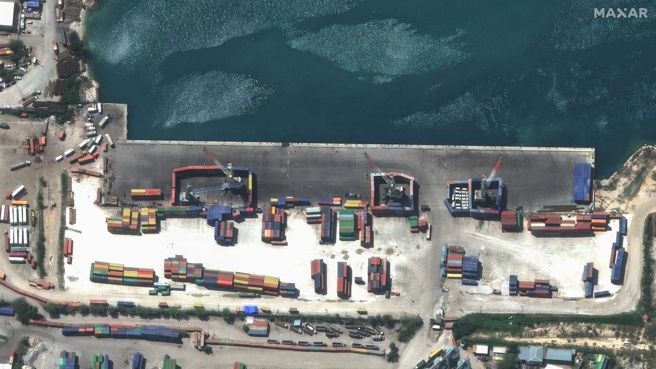 A satellite image shows shipping containers used to block access to heavy cranes, in Port-au-Prince
