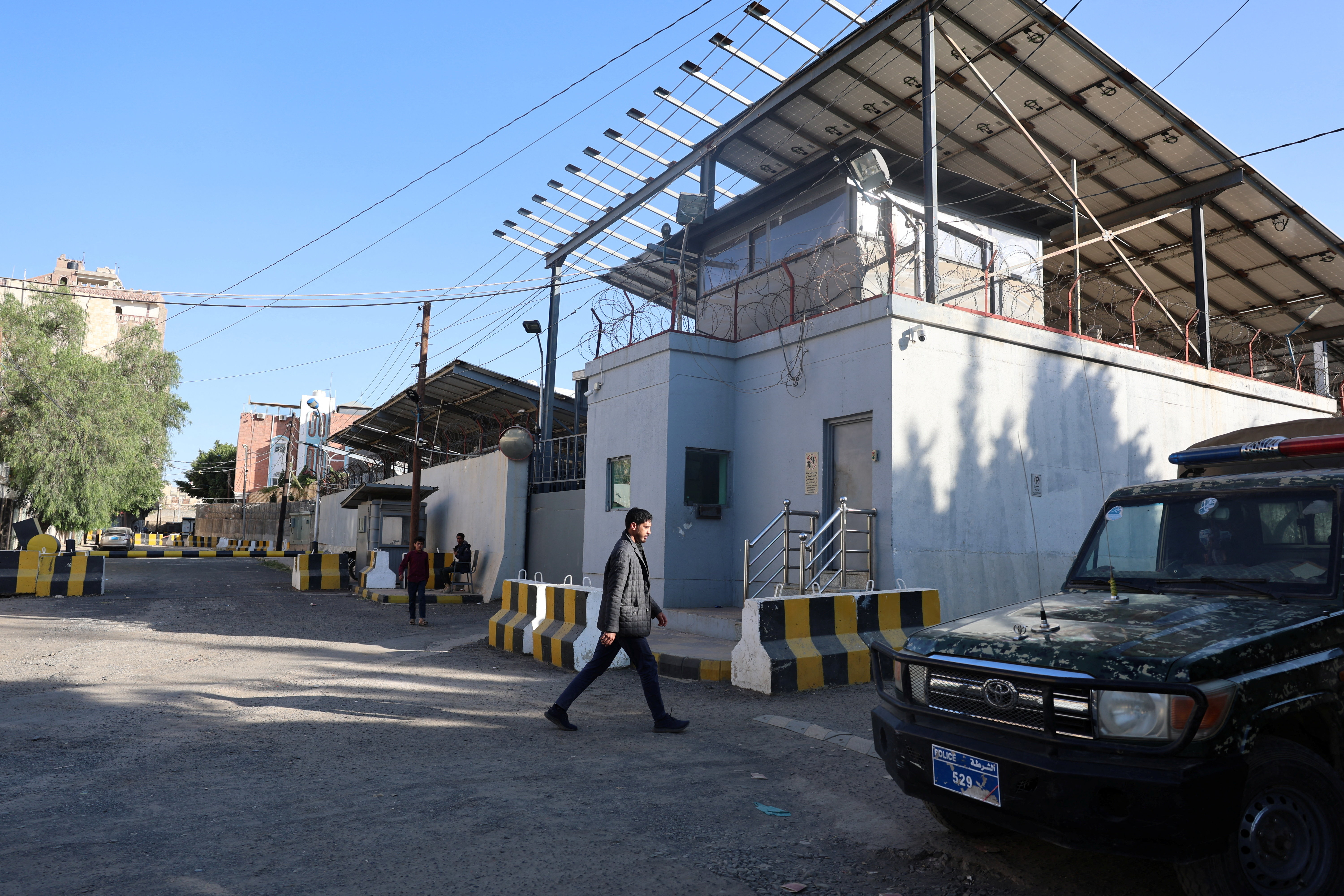 Man walks outside the United Nations compound in Sanaa