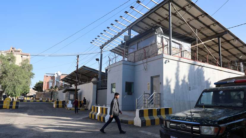 Man walks outside the United Nations compound in Sanaa