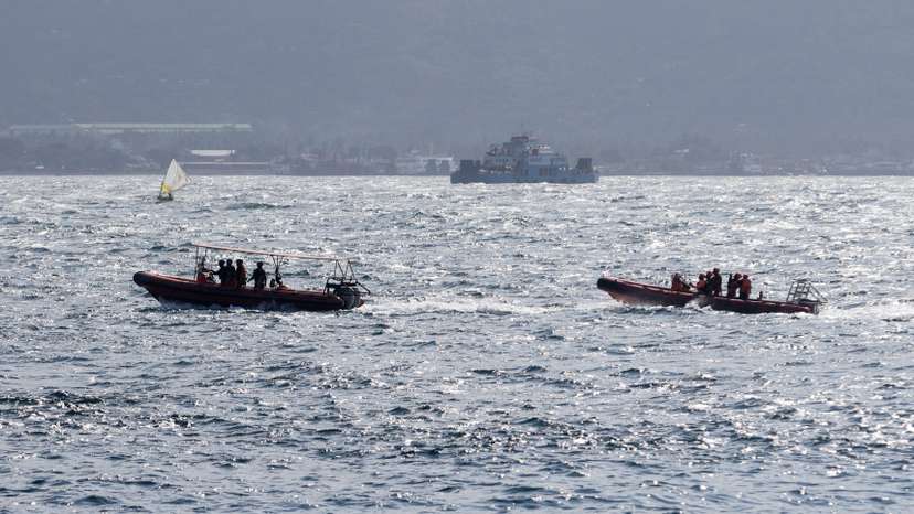 Indonesia rescue team members sail on dinghies during a search operation for missing passengers, after a ferry carrying 65 people sank near the Indonesian island of Bali, in Bali