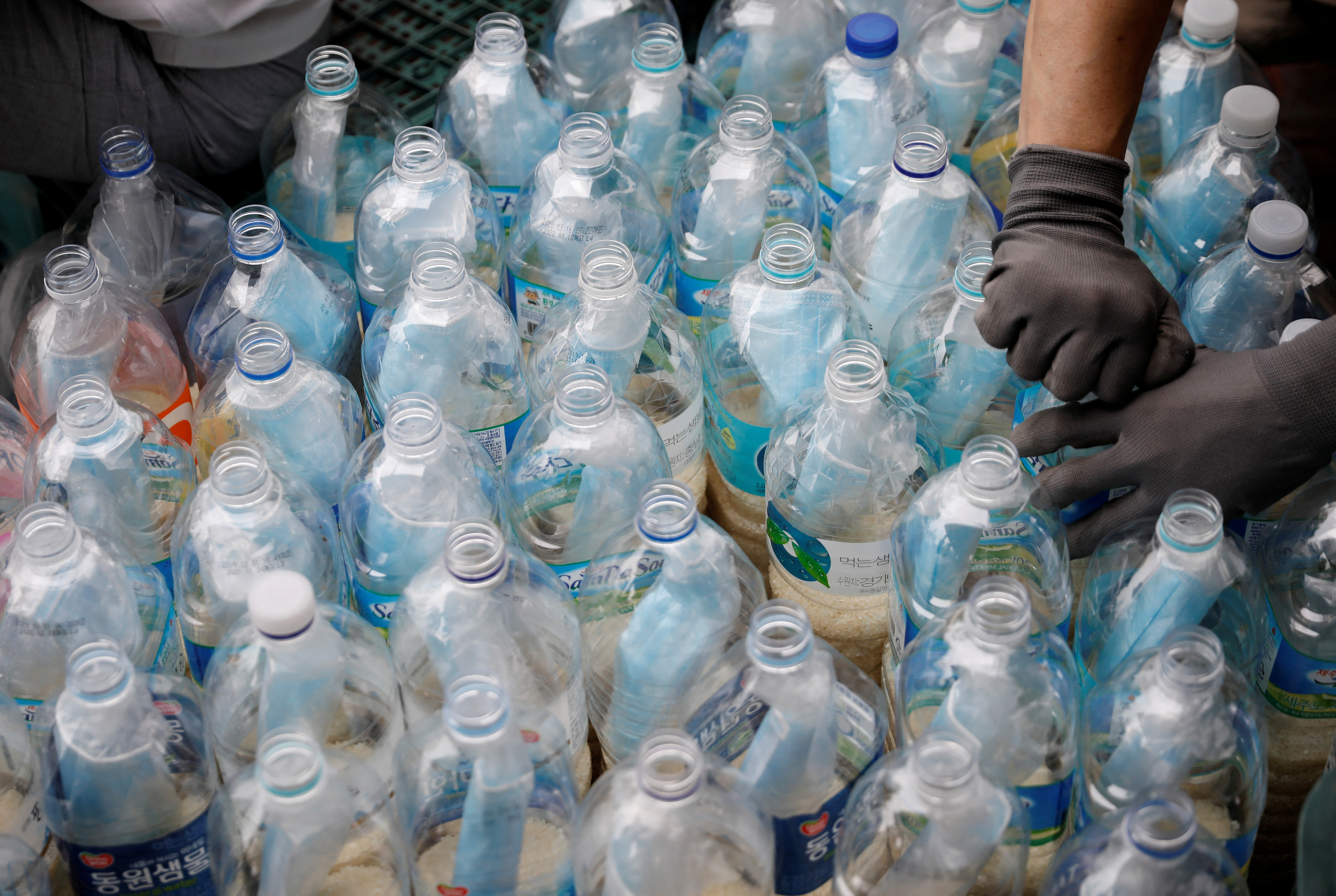 FILE PHOTO: North Korean defector group prepares plastic bottles filled with rice and masks to be sent towards North Korea