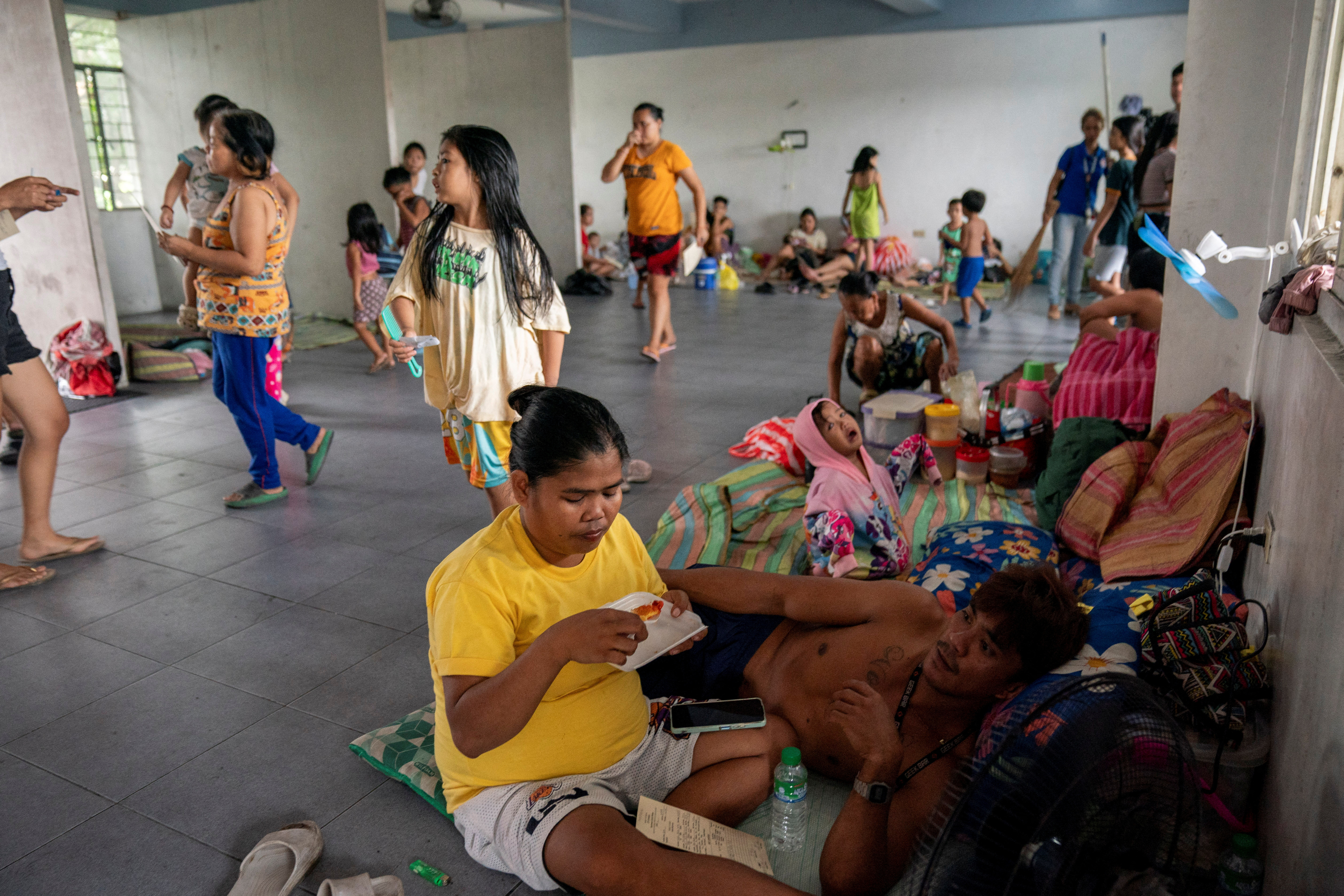 People take shelter at an evacuation site in preparation for super typhoon Man-yi, in Manila
