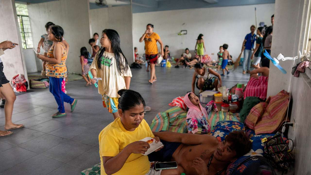 People take shelter at an evacuation site in preparation for super typhoon Man-yi, in Manila