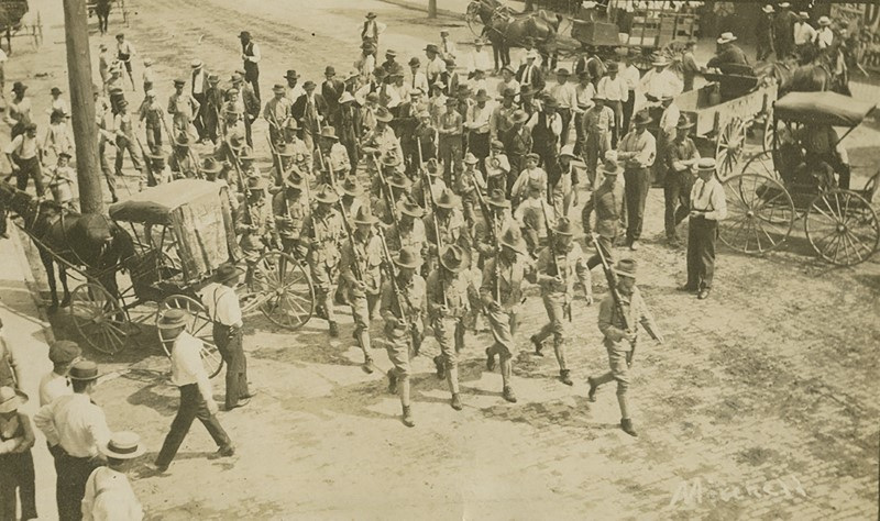 Troops march after an August 1908 race riot in Springfield