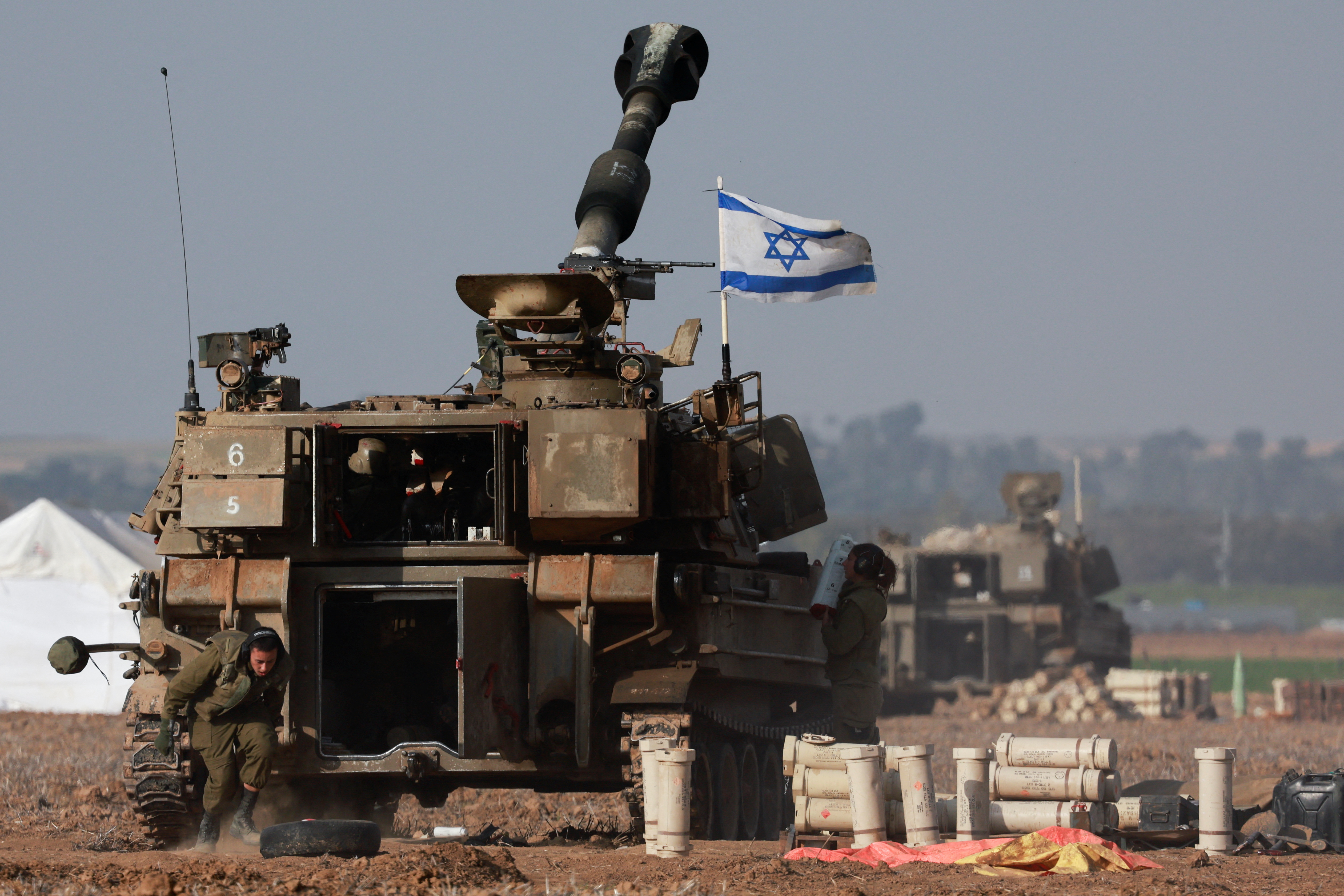 An Israeli artillery unit operates near the border with Gaza, amid the ongoing conflict between Israel and Palestinian Islamist group Hamas, as seen from southern Israel
