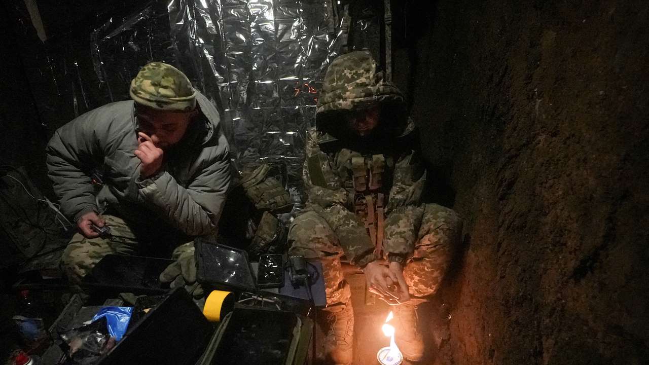 FILE PHOTO: Ukrainian servicemen warm up inside a dugout as they fly with a Vampire combat drone over positions of Russian troops near the frontline town of Bakhmut