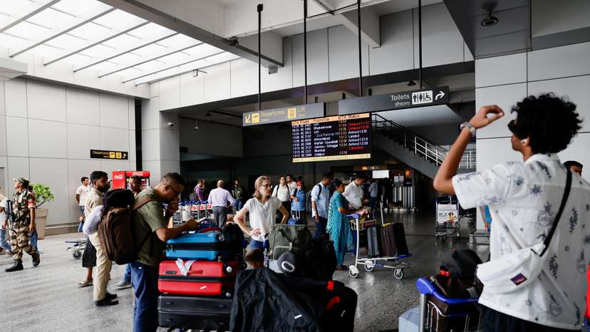 Passengers wait at Terminal 2 of Indira Gandhi International Airport in New Delhi
