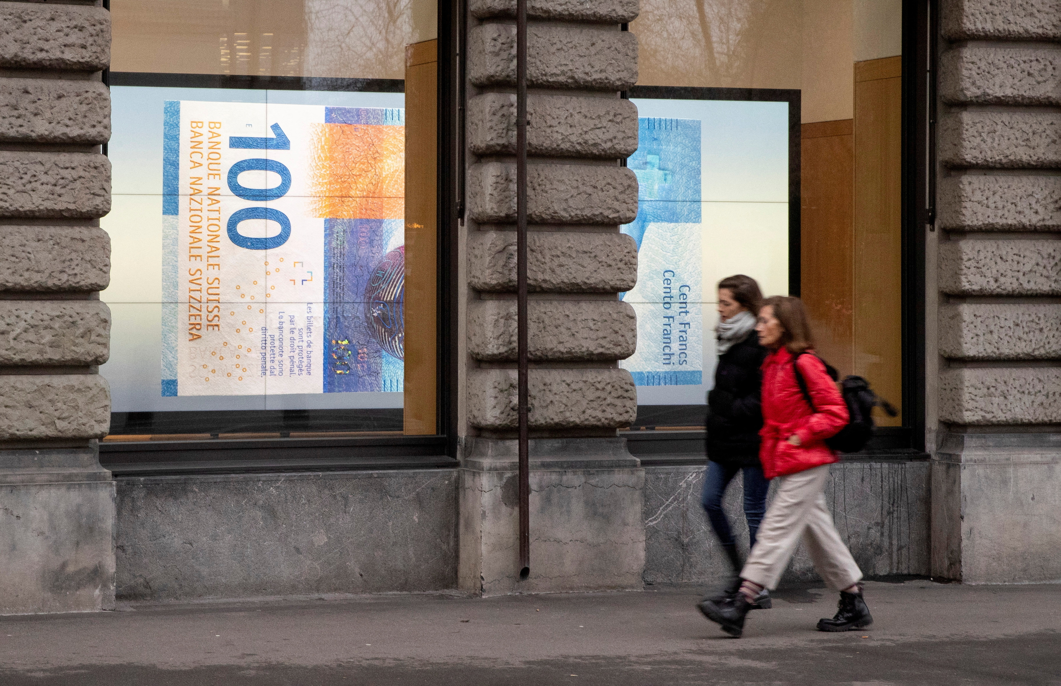 FILE PHOTO: A projection shows a 100 franc banknote in a window in Zurich