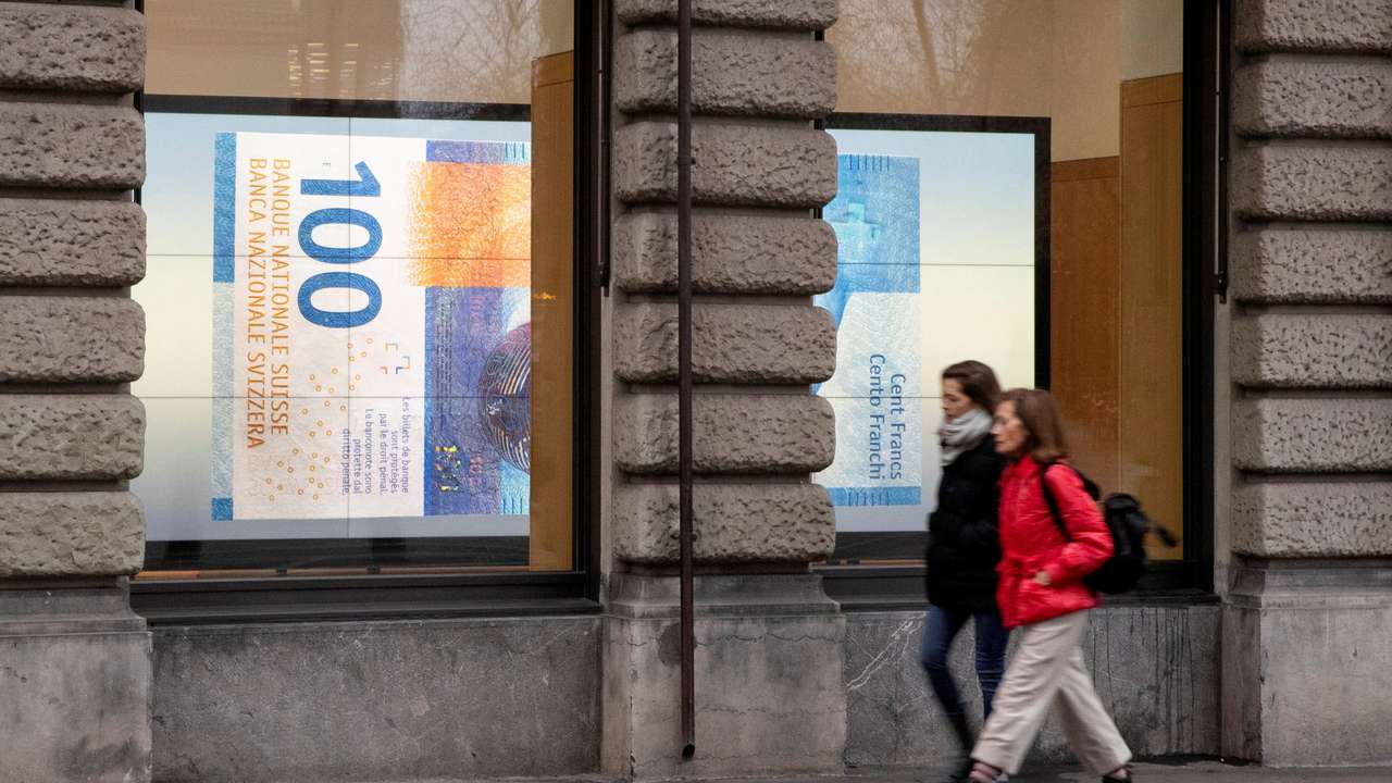 FILE PHOTO: A projection shows a 100 franc banknote in a window in Zurich