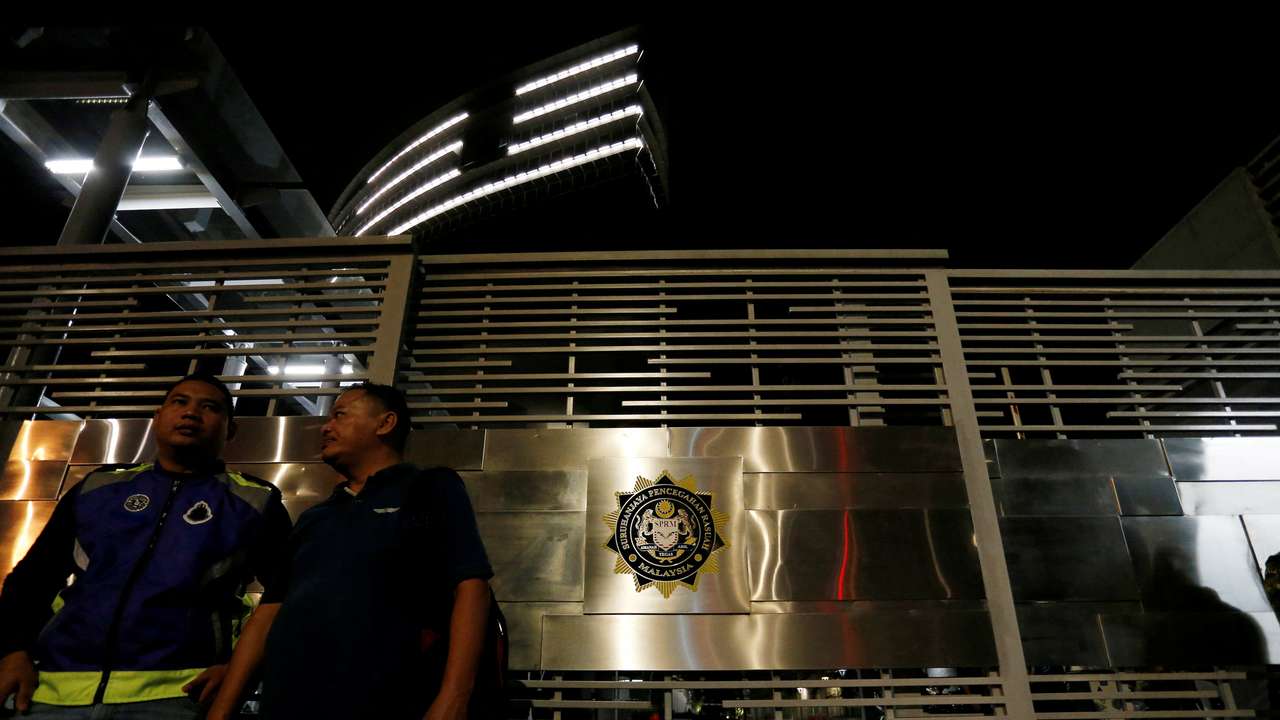 FILE PHOTO: Police officers stand guard outside the MACC headquarters in Putrajaya